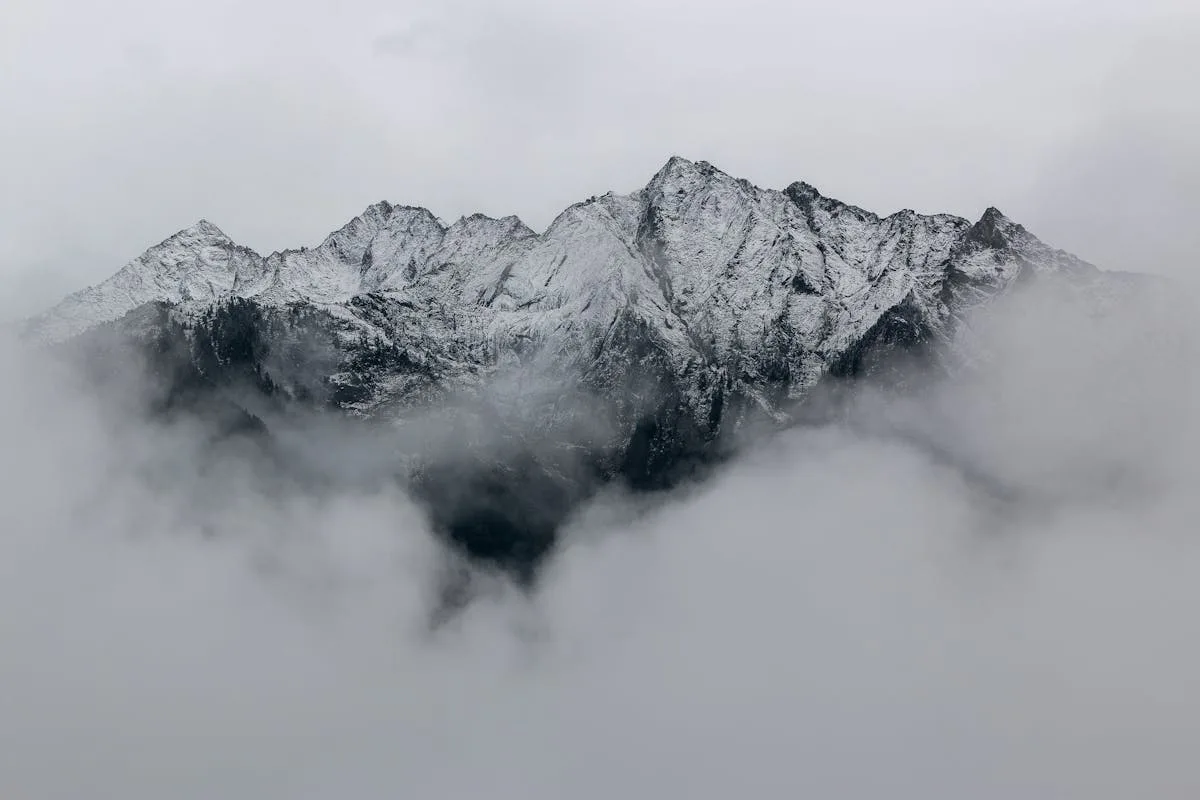 Trekkers in the Himalayas with mountain peaks behind