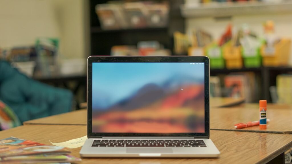 A laptop open on a bright desk