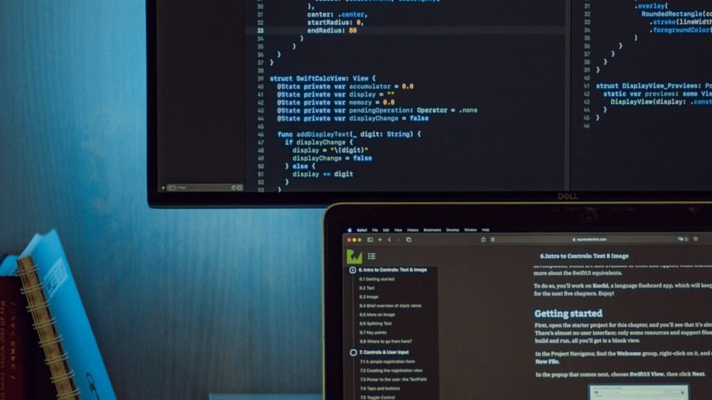 A desk with a monitor showing a site being built